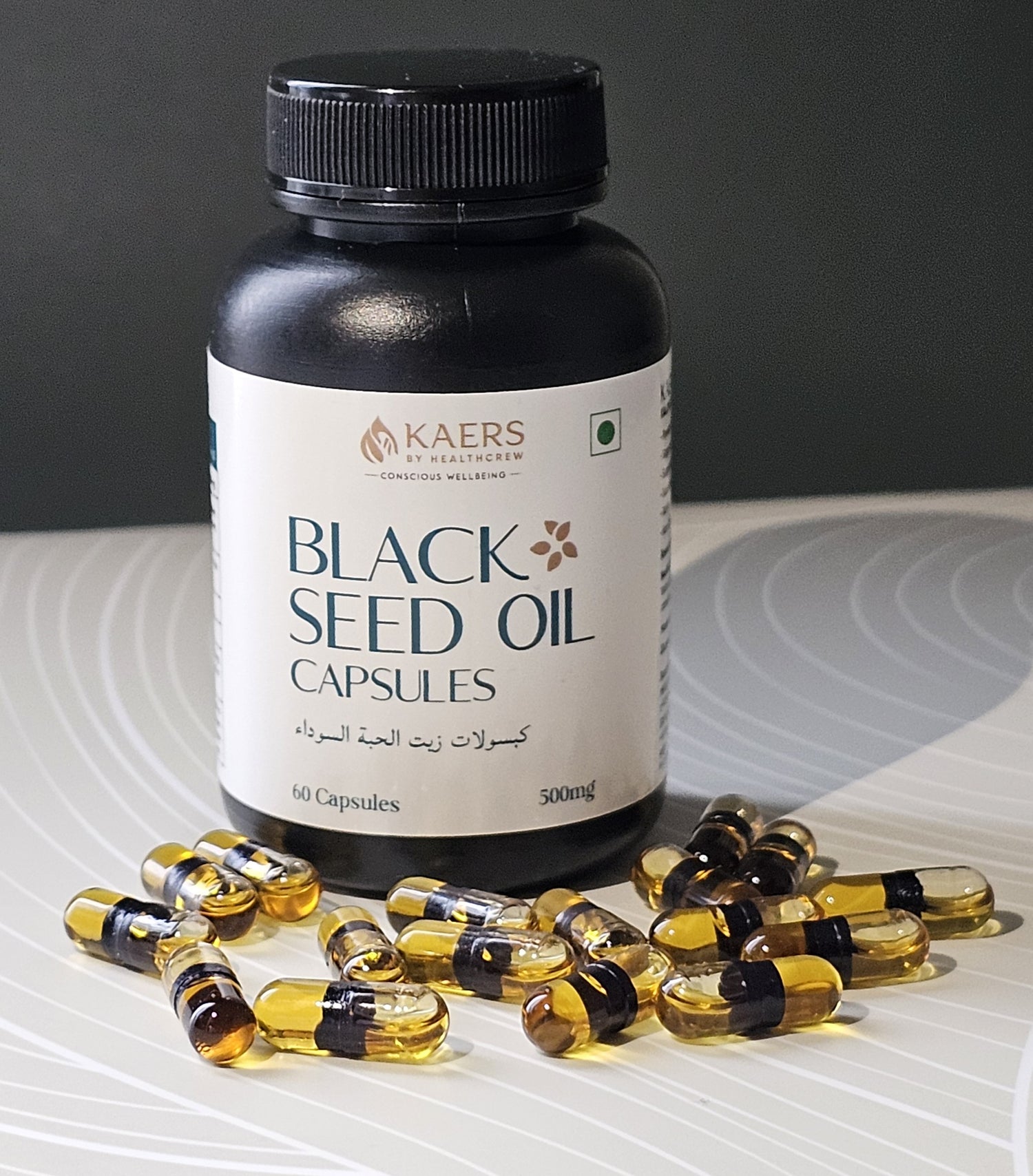 Black seed oil capsules by Black Seed Organica with a bottle on a gray background 