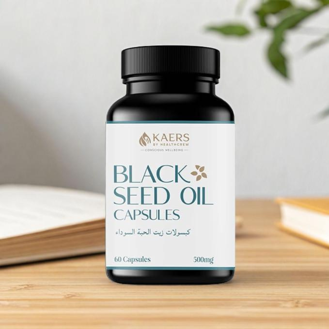 Bottle of Black Seed Oil Capsules by black seed organica on a wooden surface with a blurred background