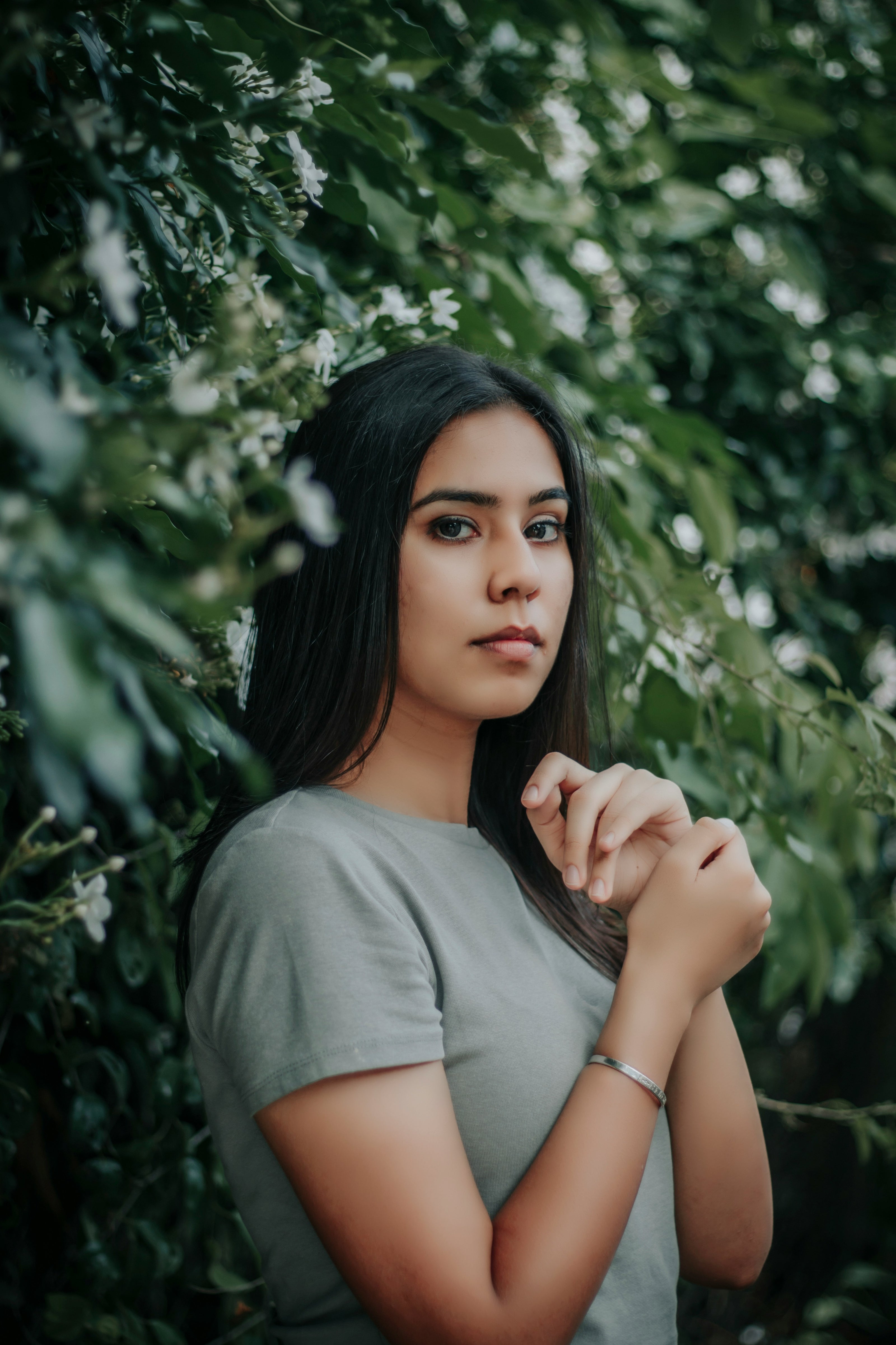Woman standing among green foliage